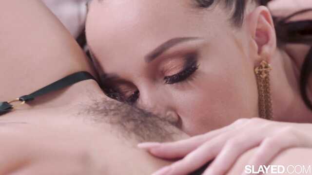 Charming actresses lasciviously caress on the bed