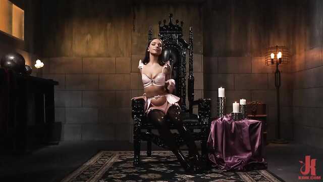 Dominatrice en tenue de latex travaille sur l'anal d'un esclave personnel