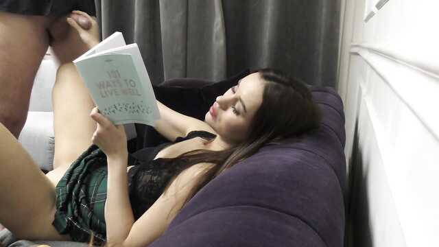 Брюнетка в короткой юбке читает книгу и дрочит член