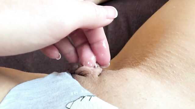 Młoda dziewczyna w majtkach bawi się z ogoloną cipką