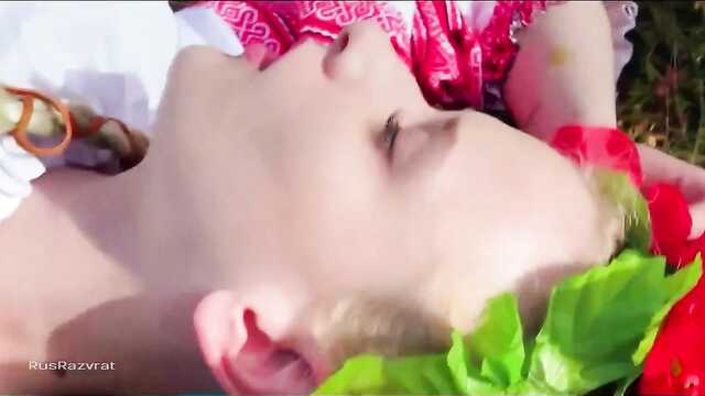 A Ukrainian woman in a national costume jerks off a pussy in a meadow